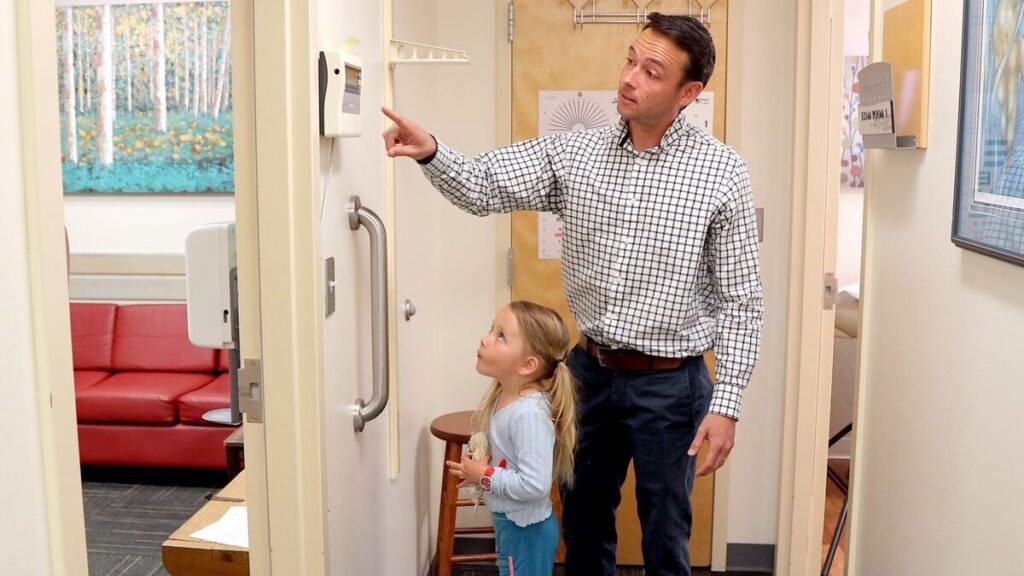 Dr. Beck with child viewing weight